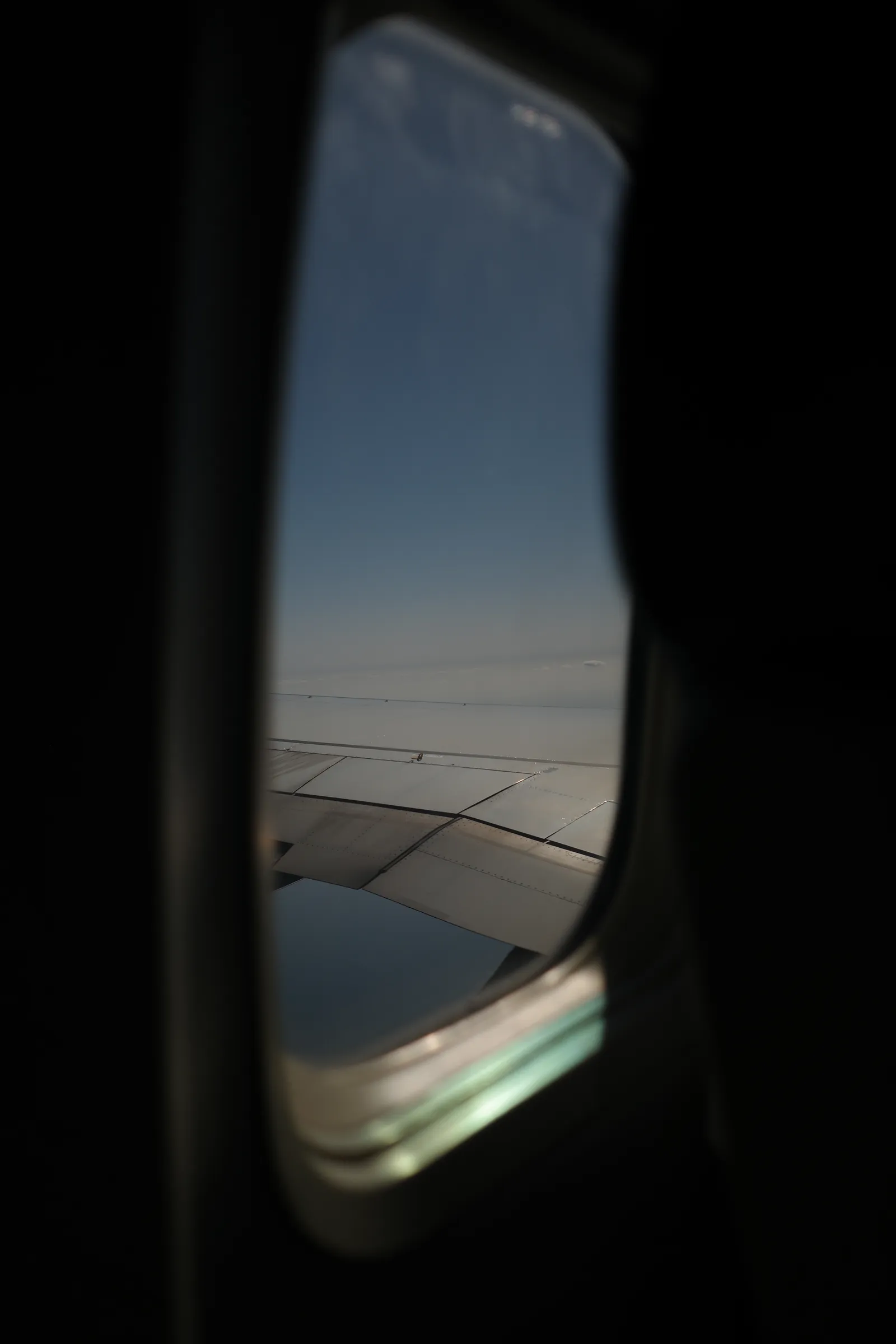 Airplane window at dusk