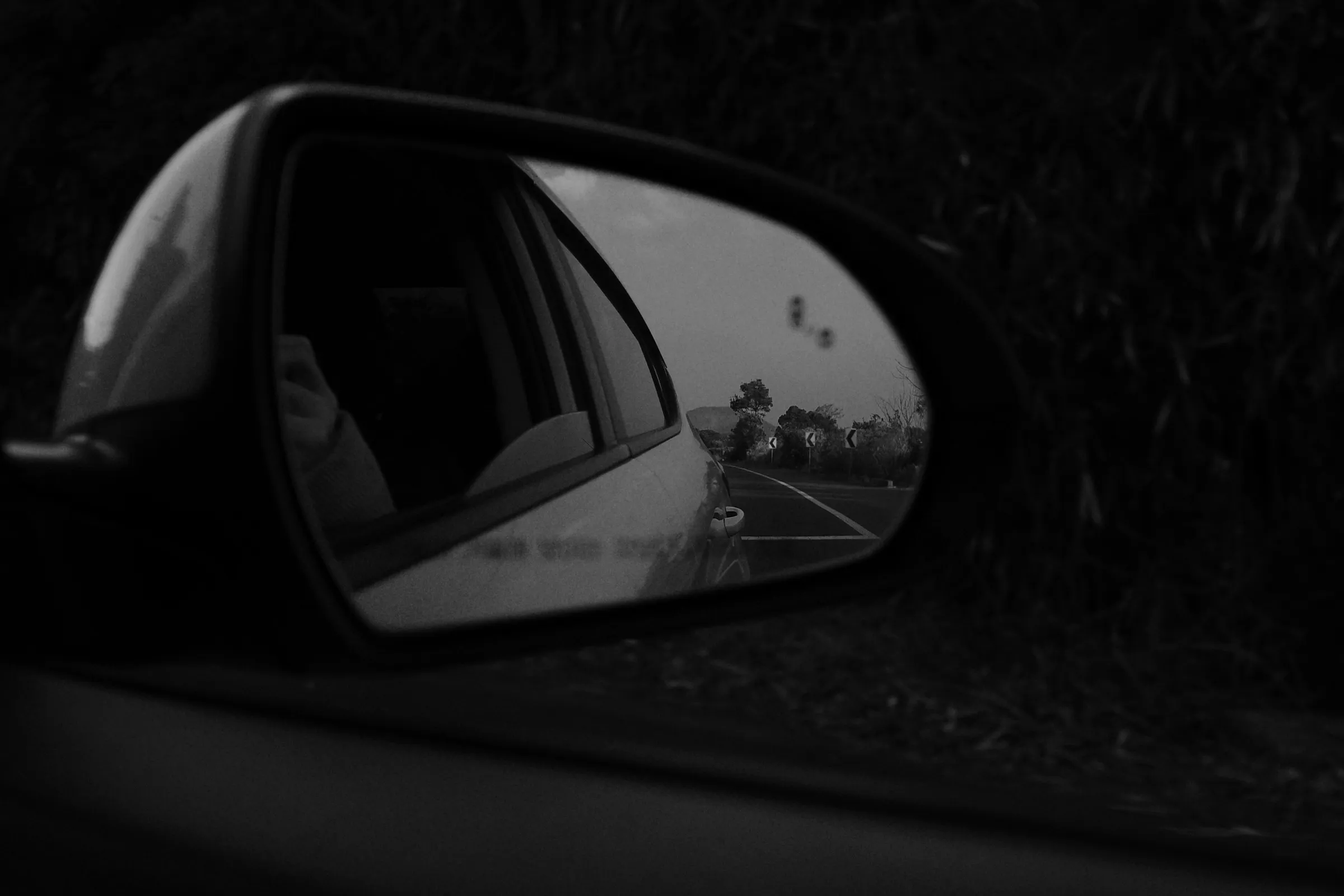 The road behind in a side mirror