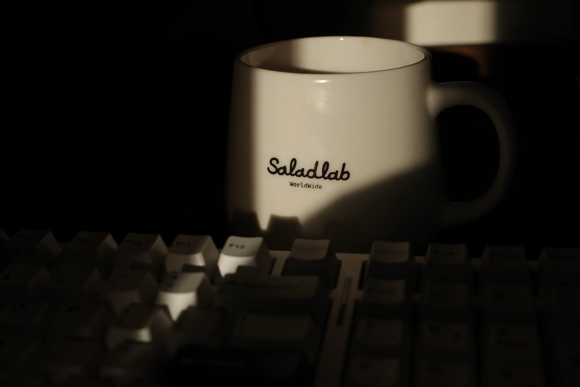 A mug beside the keyboard